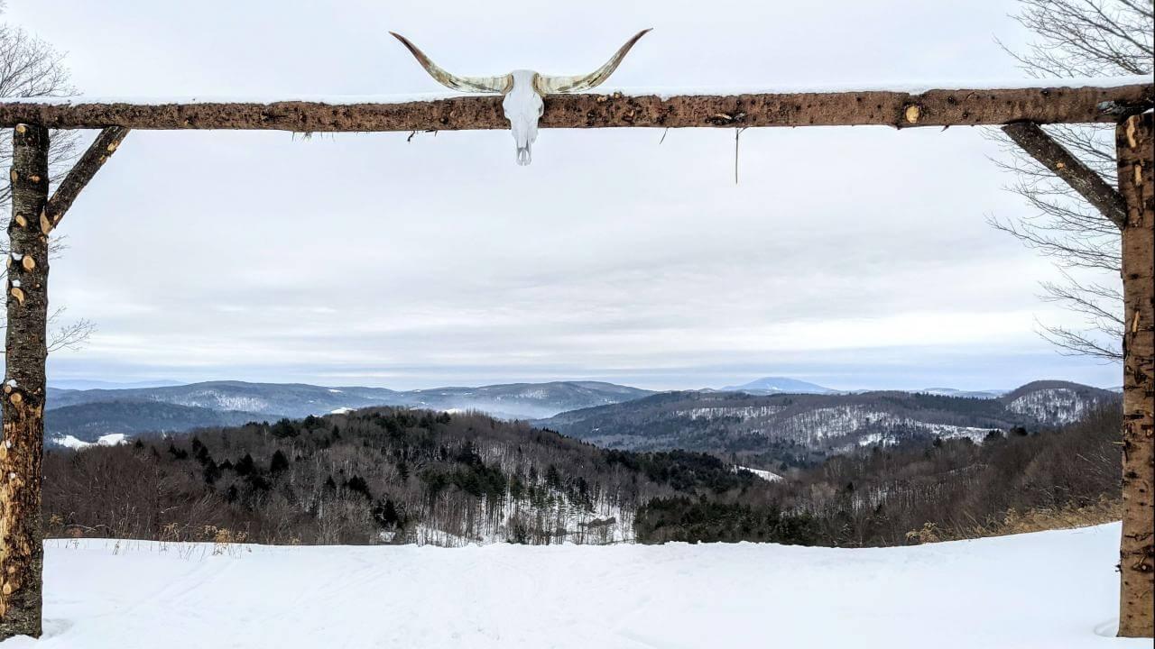 Summit vista through arch with longhorn skull