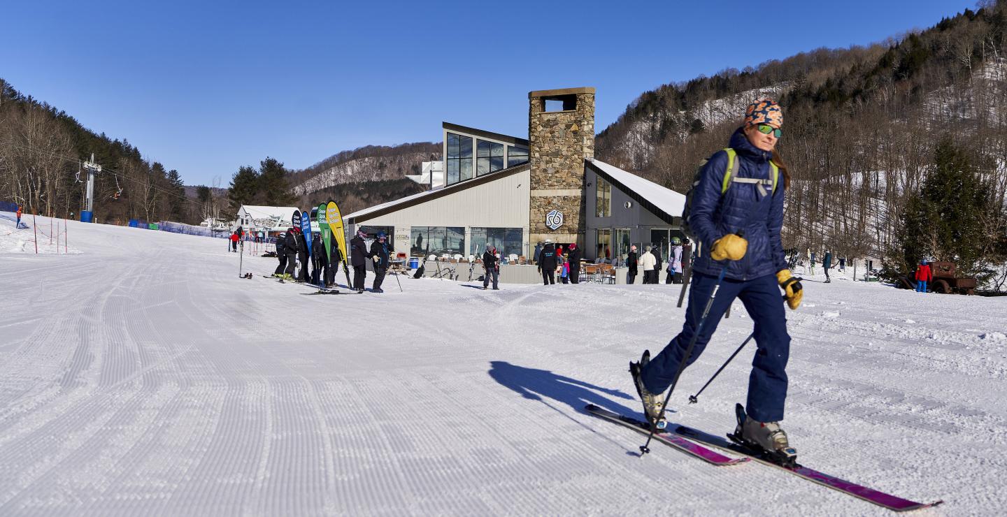 Skier leaving base area to skin uphill