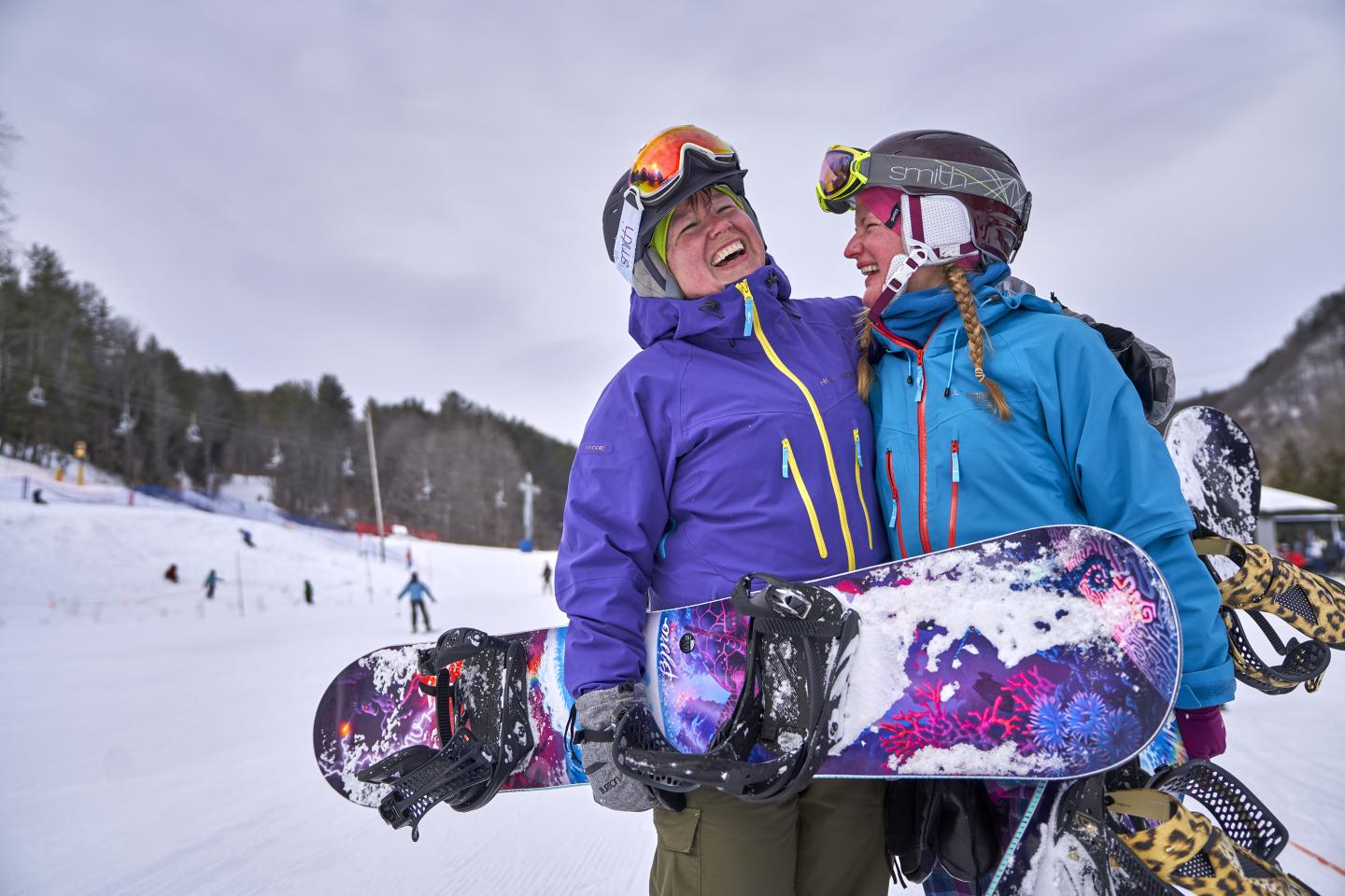 Snowboarder women laughing