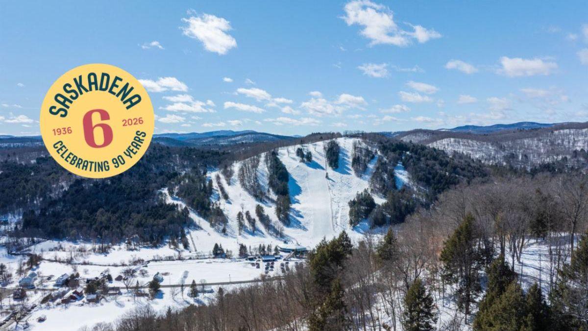 Snowy mountain ski slopes under a clear blue sky.